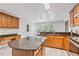 Well-lit open kitchen with granite countertops and plenty of cabinet storage at 630 Birch River Ln, Lawrenceville, GA 30043