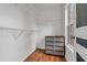 Well-organized walk-in closet with white wire shelving, wood floors, and a window for natural light at 630 Birch River Ln, Lawrenceville, GA 30043
