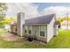 Exterior view of the back of a home with vinyl siding, chimney, windows and AC unit at 6304 Kendra Ln, Lithonia, GA 30058