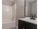 Clean bathroom featuring a vanity, framed mirror, and a shower-tub combination with a white surround at 6304 Kendra Ln, Lithonia, GA 30058