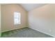 Cozy carpeted bedroom with pitched ceiling and natural light from window at 6304 Kendra Ln, Lithonia, GA 30058