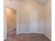 Neutral bedroom featuring plush carpeting, fresh paint, and a door leading to another room at 6304 Kendra Ln, Lithonia, GA 30058