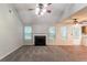 Spacious living room features a fireplace, vaulted ceiling, and large windows at 6304 Kendra Ln, Lithonia, GA 30058