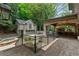 Backyard featuring brickwork, an outdoor kitchen, a guest house above the garage, a stone patio, and a hot tub at 1640 Nottingham Ne Way, Atlanta, GA 30309