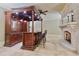 The bar area includes custom cabinetry, a stone fireplace, and seating at 1640 Nottingham Ne Way, Atlanta, GA 30309