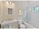 Bright bathroom featuring a white tiled shower, soaking tub, and pedestal sink at 1640 Nottingham Ne Way, Atlanta, GA 30309