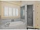 Luxurious bathroom with marble floors, a soaking tub, and a glass enclosed shower at 1640 Nottingham Ne Way, Atlanta, GA 30309