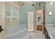 Bright bathroom features soaking tub, walk-in shower, and double vanity with white countertops at 1640 Nottingham Ne Way, Atlanta, GA 30309