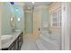 Bright bathroom with mint green walls, a tub, a double vanity, and white tile floors at 1640 Nottingham Ne Way, Atlanta, GA 30309