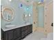 Bright bathroom with mint green walls, a double vanity, and a ornate mirrors at 1640 Nottingham Ne Way, Atlanta, GA 30309