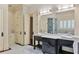 Bright bathroom with a double vanity, marble floors, and a glass shower and tub at 1640 Nottingham Ne Way, Atlanta, GA 30309