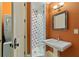 Bathroom with pedestal sink, walk-in shower with mosaic tiles, and laundry closet at 1640 Nottingham Ne Way, Atlanta, GA 30309