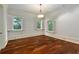 Bedroom featuring hardwood floors, white walls, and three windows with plantation shutters at 1640 Nottingham Ne Way, Atlanta, GA 30309