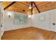 Bedroom featuring hardwood floors, wood-paneled vaulted ceiling, and plantation shutters at 1640 Nottingham Ne Way, Atlanta, GA 30309