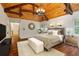 Relaxing bedroom with beautiful hardwood floors, wood ceiling beams, and a decorative chandelier at 1640 Nottingham Ne Way, Atlanta, GA 30309