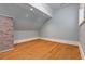 Bedroom featuring wood floors, grey walls, and a brick column at 1640 Nottingham Ne Way, Atlanta, GA 30309