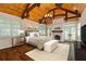 Relaxing bedroom with a fireplace, shuttered windows, wood floors, and a wood plank ceiling at 1640 Nottingham Ne Way, Atlanta, GA 30309