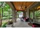 Stylish covered porch with brick columns, ceiling fan, and comfortable outdoor furniture at 1640 Nottingham Ne Way, Atlanta, GA 30309