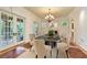 Formal dining room boasting natural light, hardwood floors, and a stylish chandelier at 1640 Nottingham Ne Way, Atlanta, GA 30309