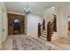 Grand foyer features a decorative brick archway, staircase, and chandelier at 1640 Nottingham Ne Way, Atlanta, GA 30309