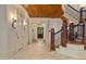 Welcoming foyer featuring custom lighting, a wood plank ceiling, and direct access to stairs at 1640 Nottingham Ne Way, Atlanta, GA 30309