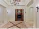 Elegant foyer with beautiful woodwork, chandelier lighting, and access to other rooms at 1640 Nottingham Ne Way, Atlanta, GA 30309
