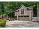 Backyard guest house above the garage with a balcony, set among lush trees, adding charm and privacy to the property at 1640 Nottingham Ne Way, Atlanta, GA 30309