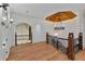 Upper hallway with wood floors and custom wood railing, illuminated by a decorative light fixture at 1640 Nottingham Ne Way, Atlanta, GA 30309
