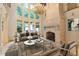 Bright living room with floor-to-ceiling windows, stone fireplace, and elegant chandelier at 1640 Nottingham Ne Way, Atlanta, GA 30309