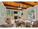 Cozy living room with wood-beam ceiling, fireplace, TV, and access to outdoor patio at 1640 Nottingham Ne Way, Atlanta, GA 30309