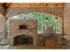 Outdoor kitchen featuring a brick pizza oven, a stainless steel grill, and pendant lights for a great entertaining experience at 1640 Nottingham Ne Way, Atlanta, GA 30309