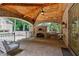 Covered outdoor kitchen featuring a brick oven, built-in grill, and brick flooring for a great cooking experience at 1640 Nottingham Ne Way, Atlanta, GA 30309