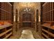 Walk-in wine cellar with brick walls, arched ceiling, and custom wooden shelving at 1640 Nottingham Ne Way, Atlanta, GA 30309