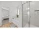 Bathroom with separate shower and tub and access to the bedroom, all neutrally decorated at 116 Eleanora Park, Loganville, GA 30052