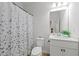 Clean, well-lit bathroom featuring a shower with a floral curtain and a modern vanity at 116 Eleanora Park, Loganville, GA 30052