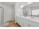Bright bathroom featuring double sinks, white cabinets, and a framed glass shower at 116 Eleanora Park, Loganville, GA 30052