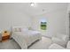 Well-lit bedroom featuring neutral tones, a comfortable bed, and a scenic outdoor view at 116 Eleanora Park, Loganville, GA 30052