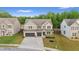 Inviting two-story home with a brick and siding exterior, spacious driveway, and professionally landscaped front yard at 116 Eleanora Park, Loganville, GA 30052