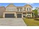 Inviting two-story home with a two-car garage, stone accents, and well-manicured lawn at 116 Eleanora Park, Loganville, GA 30052
