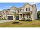 Charming two-story home with a two-car garage, covered front porch, and landscaped yard at 116 Eleanora Park, Loganville, GA 30052