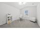 Bright home office with neutral walls, carpet, and a large window at 116 Eleanora Park, Loganville, GA 30052