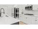 Gourmet kitchen features stainless steel appliances, white cabinets, and modern fixtures at 116 Eleanora Park, Loganville, GA 30052