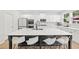 The gourmet kitchen features a large center island with seating and black and white design at 116 Eleanora Park, Loganville, GA 30052