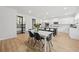Bright open kitchen features a large island, white cabinets, stainless appliances, and a wine pantry for storage at 116 Eleanora Park, Loganville, GA 30052