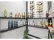 Walk-in pantry has dark shelving and storage to display a variety of wine and spirits at 116 Eleanora Park, Loganville, GA 30052