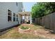 Backyard view of home featuring a covered patio, fire pit, and fenced-in yard at 319 Nobleman Way, Canton, GA 30114
