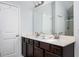 Bathroom featuring double sinks with granite countertops and wood cabinets at 319 Nobleman Way, Canton, GA 30114