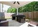 Covered patio featuring outdoor seating and a grill, perfect for entertaining at 319 Nobleman Way, Canton, GA 30114