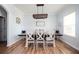 Elegant dining area featuring a rustic chandelier, seating for six, and hardwood floors at 319 Nobleman Way, Canton, GA 30114