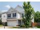 Beautiful two-story home with gray siding, black shutters, attached garage and mature tree at 319 Nobleman Way, Canton, GA 30114